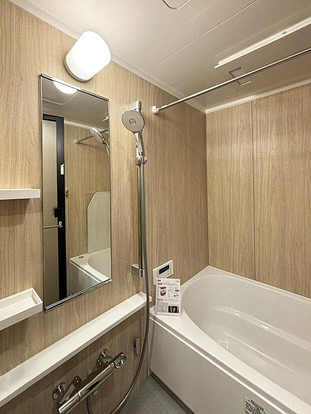 浴室｜明るい木目調のパネルを選定し、柔らかく明るい雰囲気の浴室になりました。