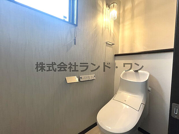 1階トイレ　アクセントクロスがお洒落な空間を演出しています。　温水洗浄便座付き