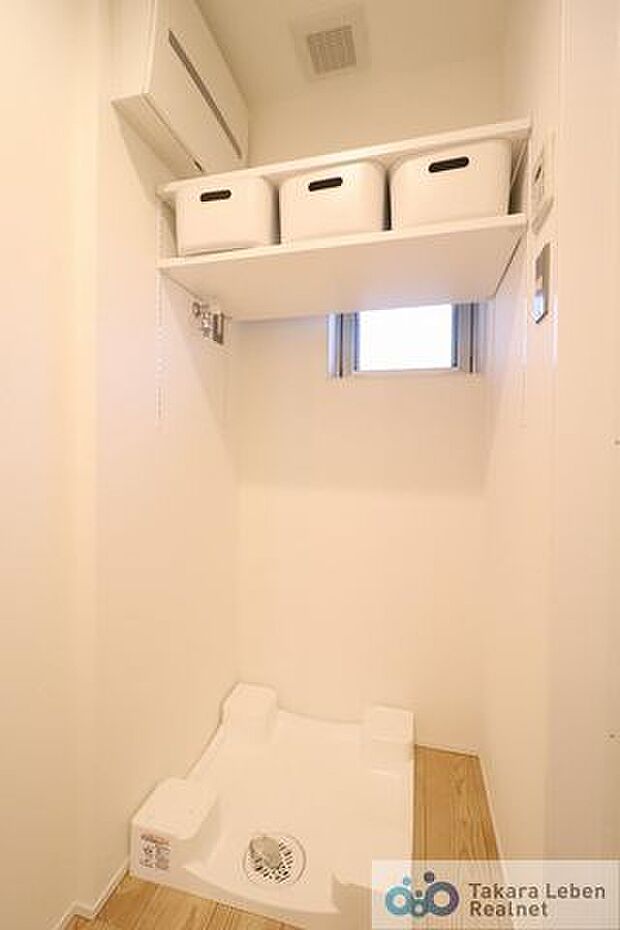 洗面スペースの化粧台背面には防水パン付きの洗濯機置場があります。また、上部には棚が設置されている為、洗剤類の収納場所としてお使いになれます。