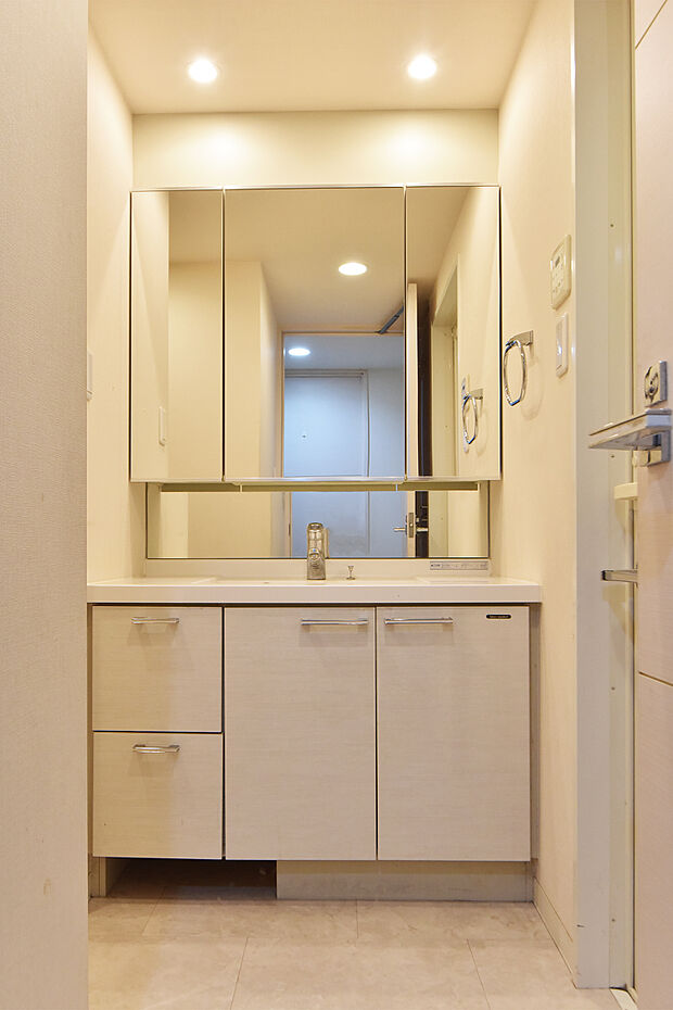 朝の身支度にも便利な三面鏡付洗面化粧台。下部にはヘルスメーターの収納スペースがあり、すっきりとした洗面室に。