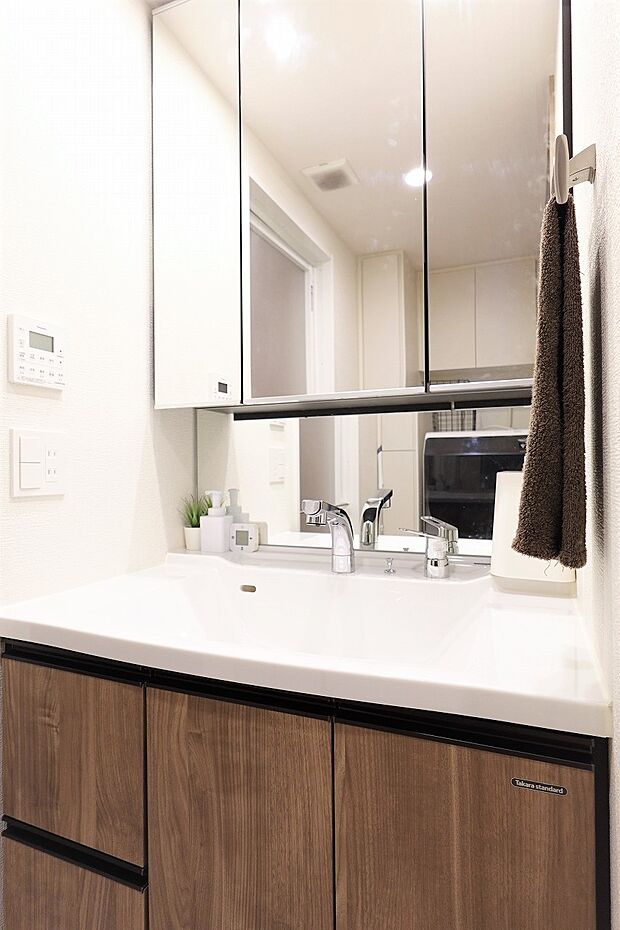 三面鏡付き洗面台　洗面室にはタオル収納もできるリネン庫もございます