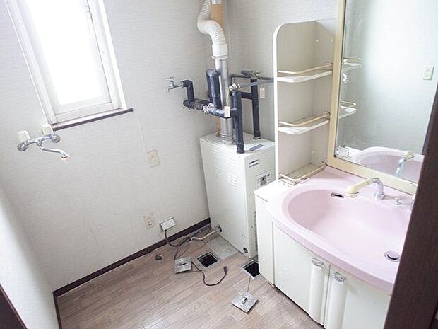 洗面化粧台はシャワーヘッドタイプ。ミラー横に造作棚があり、小物置きに便利です。