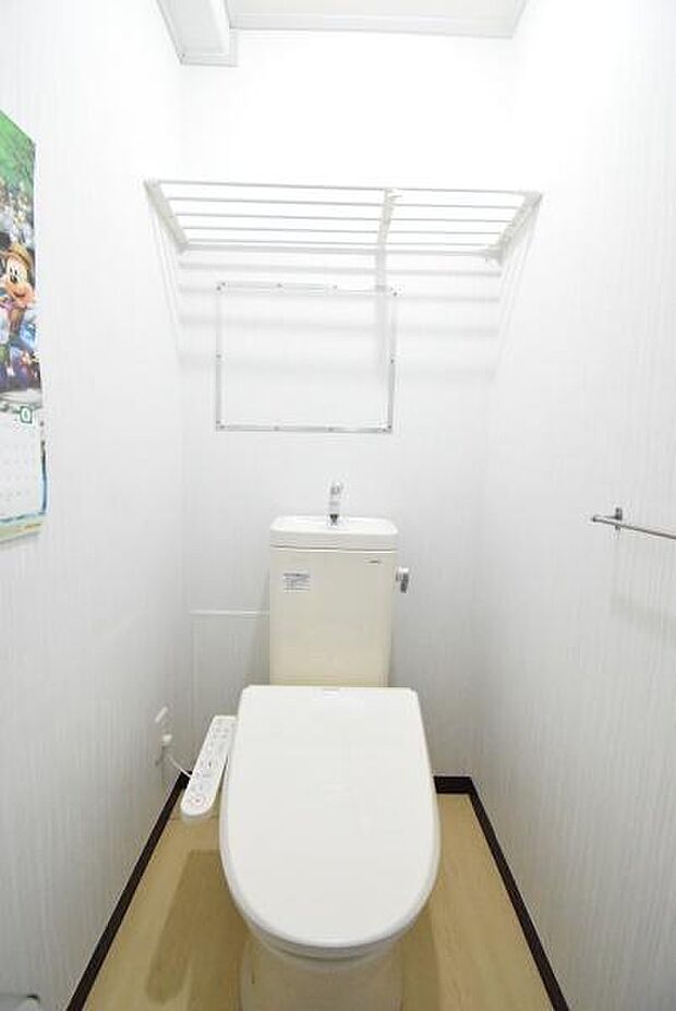 ウォシュレット機能付きのトイレです。後部には、トイレットペーパーなどを置いて置ける網棚があります。